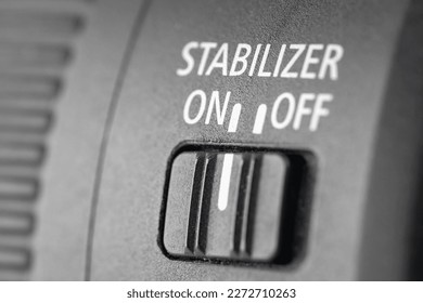 Close-up of the stabilization of the switch button in a modern lens, macro photography