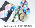 Closeup of a stack compact disc CD and DVD. High resolution compact disc texture CD or DVD. Disks CD, DVD for background. CD, DVD disc unsorted on the ground with light effect. isolated background