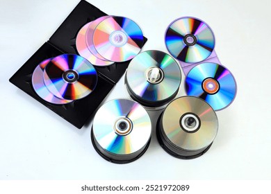 Closeup of a stack compact disc CD and DVD. High resolution compact disc texture CD or DVD. Disks CD, DVD for background. CD, DVD disc unsorted on the ground with light effect. isolated background - Powered by Shutterstock