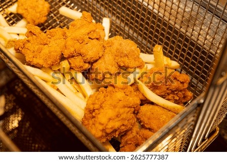 Close-up of a stack of deep-fried boneless chicken pieces. Crispy outside, juicy and succulent inside, smelling delicious. 