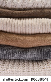 Closeup Stack of different warm sweaters background

