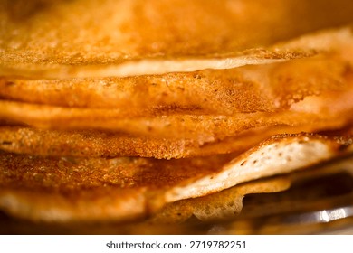 
A close-up of a stack of fried pancakes. Maslenitsa.