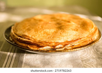 
A close-up of a stack of fried pancakes. Maslenitsa.