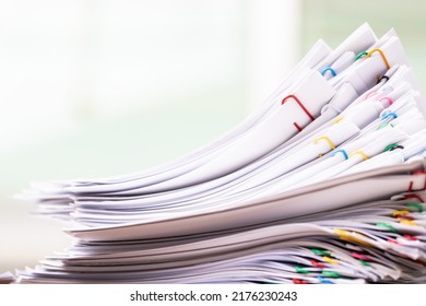Close-up of Stack of Group report papers Document clipped in color clips, business, and education concept.