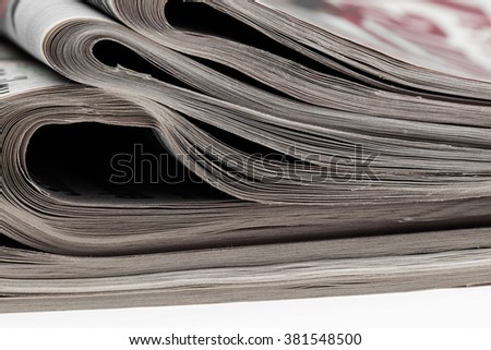 Closeup of stack of newspapers. Assortment of folded newspapers isolated on white. Breaking news, journalism, power of the media, newspaper and magazine ads and subscription concept.