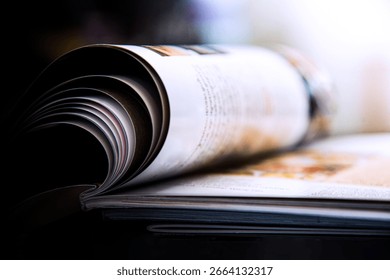 Close-up of a stack of open books on a desk in an office. Selective focus
