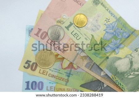 Close-up of stack of Romanian currency banknotes and coins Leu 100 lei 50 lei 10 lei 1 leu