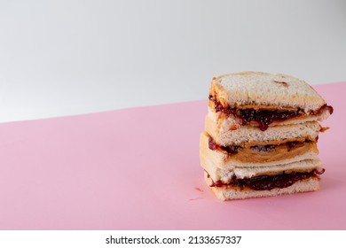 Close-up of stacked peanut butter and jelly sandwiches on table against gray background. unaltered, peanut butter and jelly sandwich, copy space, healthy food, halved and breakfast. - Powered by Shutterstock