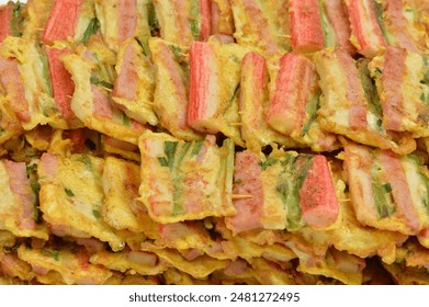 Close-up of stacked Sanjeok skewers made of ham, Matsal(crab meat), chives and King oyster mushroom, South Korea
 - Powered by Shutterstock
