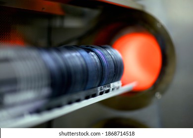 A closeup of stacked silicon wafers being processed as it enters the furnace