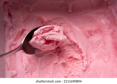 Close-up Stainless Steel Table Spoon Sweetened Frozen Food Sweet Strawberry Flavour Pink Ice Cream Made From Real Fruit In White Paper Square Box Container Texture Background. Unhealthy Food Concept