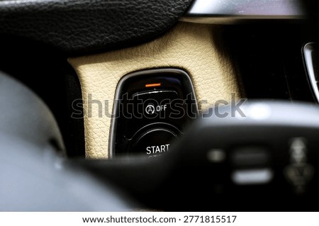 Close-up of start stop button in modern car interior dashboard