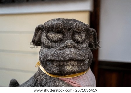 Close-up of a statue of a komainu, one of the most ubiquitous and recognizable symbols of sacred sites in Japan. It stands guard at the entrances of countless Shinto shrines and Buddhist temples.
