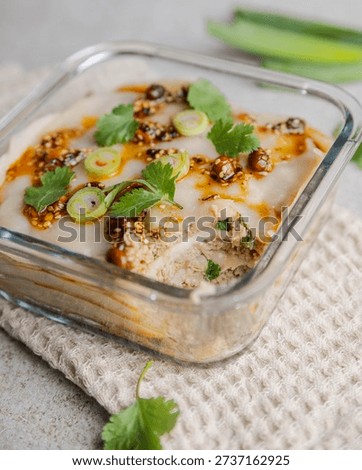 Close-up of a steamed dumpling lasagna featuring layers of thin dumpling dough and seasoned ground pork, cooked to perfection. A modern Asian-inspired comfort food dish, ideal for culinary photography, recipe content, and foodie trends.