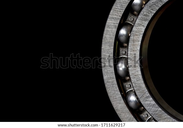 Closeup\
of Steel Roller bearings on black\
background.\
