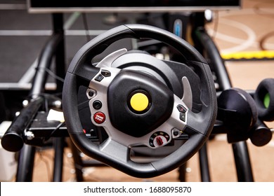 Close-up of a steering wheel of a car simulator
