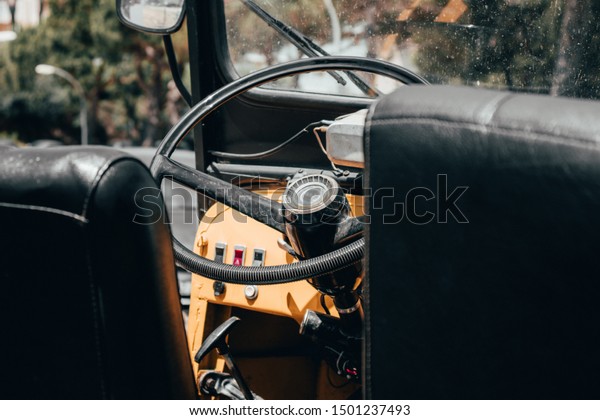 Closeup\
of a steering wheel of a desert ride sports openroof yellow orange\
car on the street. Offroad and hunting\
concept.