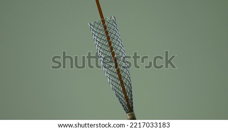 Close-up of a stent deployment prior to insertion. The metal mesh of the stent provides restoration of the elasticity of the walls during obstruction. The concept of stenting.