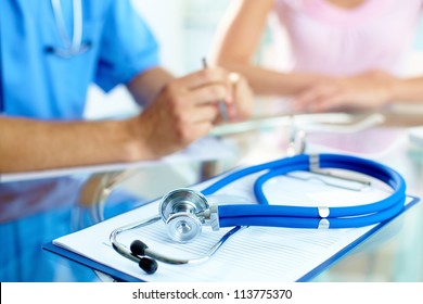 Close  up stethoscope   paper background doctor   patient hands