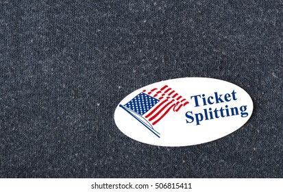 Closeup of a sticker with an American flag and the words "Ticket Splitting" placed on a navy shirt.