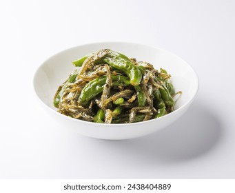 Close-up of Stir-fried Shishito Peppers with dried anchovies and shishito peppers on dish and white floor, South Korea
 - Powered by Shutterstock