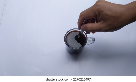 closeup stirring a hot cup of coffee on a white background - Powered by Shutterstock