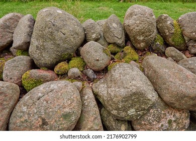 Closeup of a stone wall made of boulders and rocks outside. Background of rustic, rural building and masonry material. Historic housing design or antique architecture of an urban structure outdoors