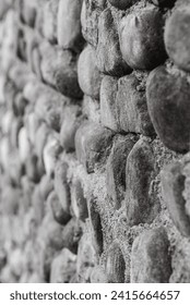 A closeup of a stone wall texture in grayscale
