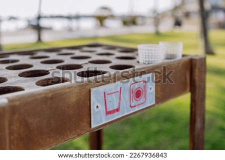 Close-up of storage table for empty glasses on the beach.