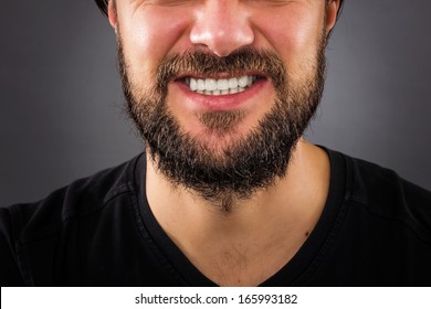 Closeup of  stressed man mouth isolated on gray background