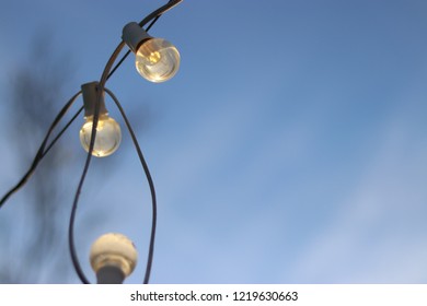Closeup of string of lights at dusk