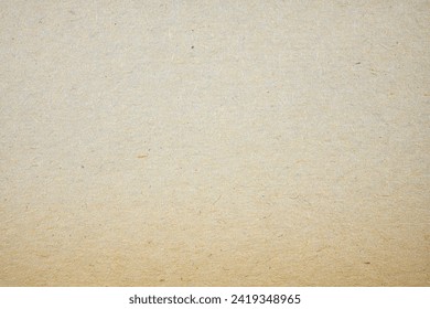 Close-up of the structure of an old sheet of light-colored cardboard. 