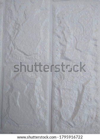 A close-up of the structure of a white plastic wall with an arbitrary pattern.