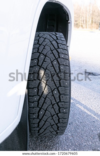 Closeup studded\
tires. Tire service\
concept.