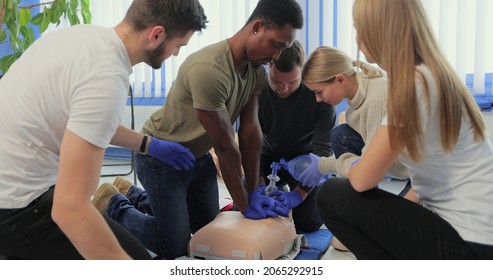 Closeup of students practicing CPR chest compression on dummy. - Powered by Shutterstock