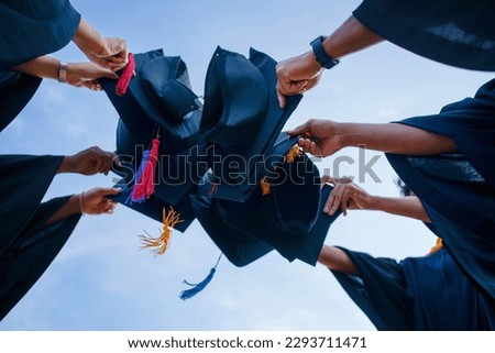 Close-up of Students throwing in the Air Blue sky graduation hats in the air celebrating