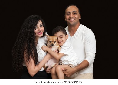 Closeup Studio Family Portrait Of A Young Loving Couple With Cute Baby And Dog. High Quality Photo