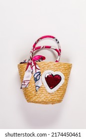 Closeup Studio Isolated Shot Of Fashionable Asian Modern Style Handmade Handicraft Woven Weaving Rattan Lady Woman Handbag Purse Decorated With Colorful Clothing And Heart Shape On White Background.