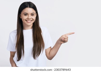 Close-up studio portrait of a beautiful brown haired teenager girl, smiling looking at camera, wearing white t-shirt, isolated on white background, showing copy space for advertising text. Mockup - Powered by Shutterstock