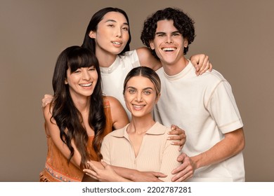 Close-up Studio Portrait Of A Diverse Group Of Four People Smiling On A Neutral Background