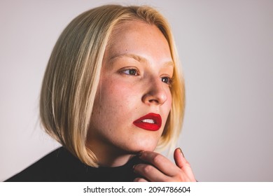 Closeup Studio Shot Of A Beautiful Young Woman Posing Against A Grey Background. Portrait Of A Beautiful Woman With Natural Make-up And Red Lipstick. Studio Portrait Of A Beautiful Girl 