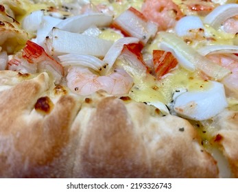 Close-up Of Stuffed Seafood Pizza With Cheese, Onion, Prawn, Squid, And Crab Stick. Stuffed Crust Pizza With Cheese