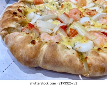 Close-up Of Stuffed Seafood Pizza With Cheese, Onion, Prawn, Squid, And Crab Stick. Stuffed Crust Pizza With Cheese