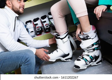 Closeup Of Stylish Fashionable Ski Boots On Female Legs During Fitting In Shop Of Sports Equipment