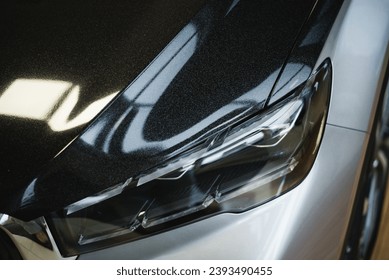 Close-up of stylish gray car luxury front headlight design outdoors. High quality photo - Shutterstock ID 2393490455