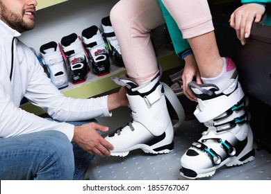 Closeup Of Stylish Ski Boots On Female Legs During Fitting In Shop Of Sports Equipment