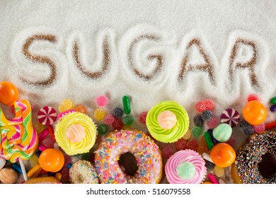 Close-up Of Sugar Written On Sugar Powder On Table