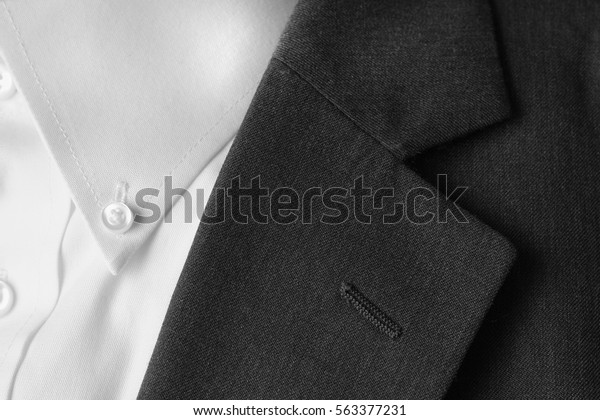 Closeup of suit buttons and lapel for business or\
formal wear