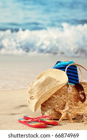 Closeup Of Summer Beach Bag With Items On Sandy Beach