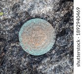 A closeup of summit geological survey marker on the top of Mount Marcy, Adirondacks Upstate New York